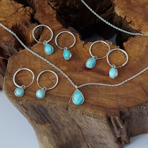 💧 Larimar tear drop gemstone necklace with fine silver chain displayed on textured brown wood.