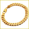 A gold chain bracelet with a lobster clasp, arranged in a circular shape on a white background.
