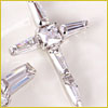 A close-up of a silver cross pendant with clear, faceted gemstones on a light background.