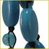 Close-up of blue oval and round beads strung together with black cord, set against a white background.
