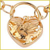 Gold heart-shaped pendant with an intricate cut-out design, attached to a chain with large circular links.