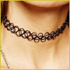 Close-up of a persons neck wearing a black, stretchy, tattoo-style choker necklace.