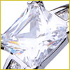 Close-up of a large, clear, rectangular diamond set in a shiny, silver metal ring.