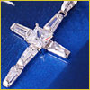 A diamond cross pendant with baguette-cut stones on a blue background.