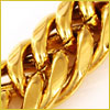 Close-up of a shiny, gold chain link bracelet against a light background.