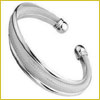 Silver cuff bracelet with a smooth, polished finish and subtle ridged design, shown against a plain white background.