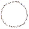 A delicate silver necklace with an intricate, twisted design, laid out in a circle on a white background.