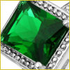 Close-up of a square-cut green gemstone set in a silver ring with a decorative border.