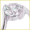 Close-up of a silver ring with a large, round, clear gemstone in a prong setting.