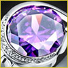 Close-up of a faceted purple gemstone set in a silver ring with small clear stones on the band.