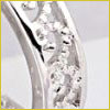 Close-up of a silver ring with embedded clear gemstones, displayed against a white background.