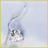 A close-up of a silver earring with a clear gemstone, displayed on a light blue background.