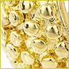 Close-up of a shiny, textured gold surface with raised round bumps, possibly part of a decorative object or jewelry.
