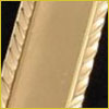 A close-up of a gold picture frame with a textured, twisted rope design along the edge.