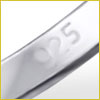 Close-up of a silver ring stamped with 925, indicating it is made of sterling silver.