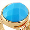 Gold ring with a large, faceted blue gemstone set in an oval shape.