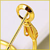 Close-up of a gold earring with a latch back clasp, highlighting the earrings fastening mechanism.