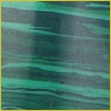 Green malachite stone surface with dark and light green stripes and a soft gradient.