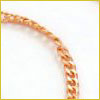 Close-up of a gold chain bracelet or necklace on a white background, showing its interlocking links.
