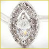 A marquise-cut diamond ring with a halo of small round diamonds set in a silver band.
