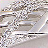 Close-up of a silver and diamond-studded object, possibly part of a piece of jewelry or decorative accessory.