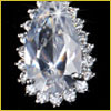 A large, pear-shaped diamond surrounded by smaller round diamonds, all set against a black background.