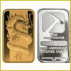 A gold bar with a dragon design next to a silver bar labeled The One Ounce Fine American Silver Coin..