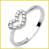 Silver ring with a heart-shaped design encrusted with small clear gemstones on a plain band, shown on a white background.
