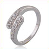 Silver wraparound ring with small clear gemstones set along the top, displayed on a plain white background.