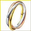 A tricolor rolling ring with intertwined yellow, white, and rose gold bands on a white background.