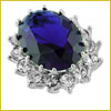 Oval-shaped deep blue gemstone ring with a silver setting and small clear stones around the main gem.