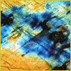 Abstract painting with vibrant blue and yellow colors, featuring textured brushstrokes and intersecting lines.