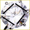 Close-up of a round, faceted diamond set in a metal prong setting, reflecting light and appearing shiny.