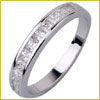 A silver ring with a row of small, square-cut diamonds embedded along the band.