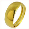 A shiny, smooth gold ring with a rounded band on a white background.